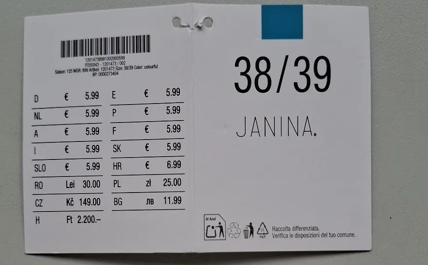 Etykieta odzieżowa z rozmiarem 38/39 dla „JANINA” z cenami w różnych walutach i kodami produktów. Etykieta odzieżowa z rozmiarem 38/39 dla „JANINA” z cenami w różnych walutach i kodami produktów.