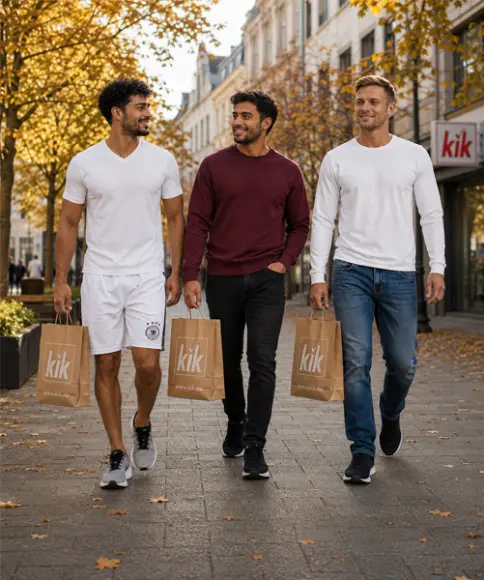 Trzech mężczyzn w sportowych i jesiennych stylizacjach casualowych z torbami KiK podczas spaceru po mieście